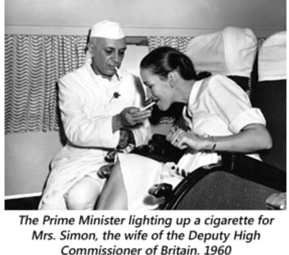 Nehru, Prime Minister of India lighting the cigarette for Mrs Simon, wife of Deputy High Commissioner of Britain, 1960.
