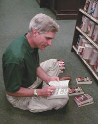 Dave signing books